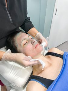 Nurse takes Blue Peel off patient's face