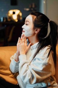 Woman applying face care product